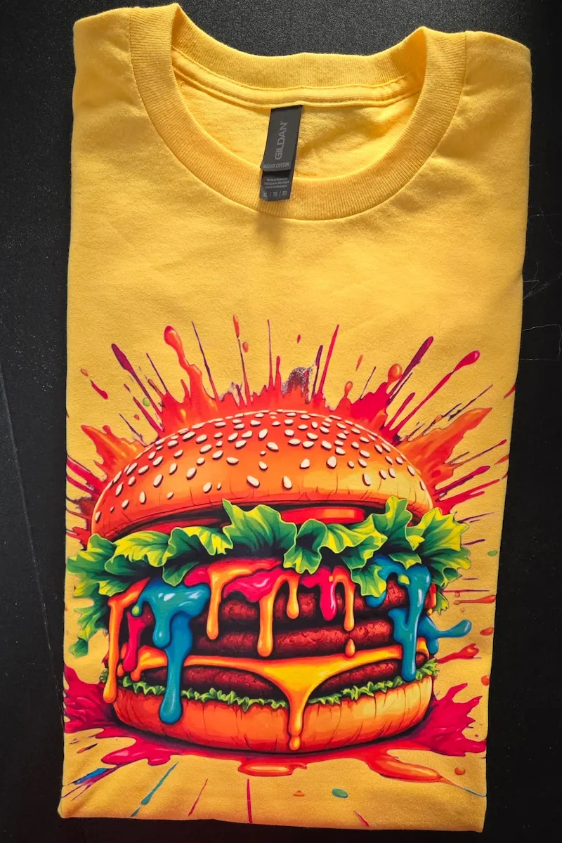 Custom printed t-shirt featuring a colorful burger graphic design created with high-quality DTF printing