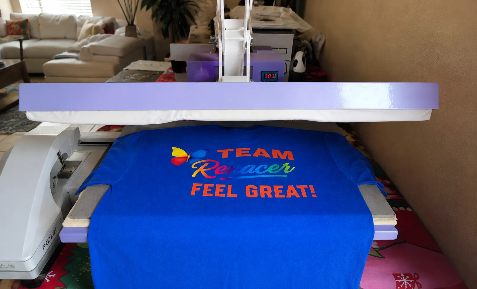 Custom DTF t-shirt printing in progress using a professional heat press machine. Vibrant full-color design applied to a blue shirt by VG Prints 4 You in Coral Springs, Florida.