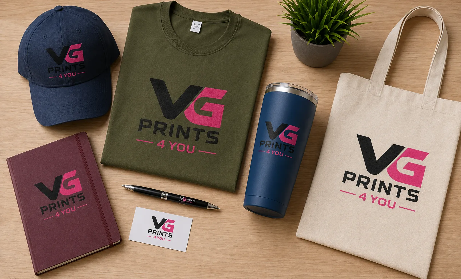 Custom promotional products featuring branded apparel, embroidered cap, printed t-shirt, stainless steel tumbler, tote bag, notebook, business card, and pen by VG Prints 4 You.